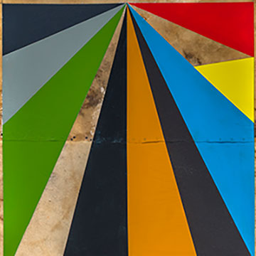 a large shield shape painted with bright triangles of various sizes